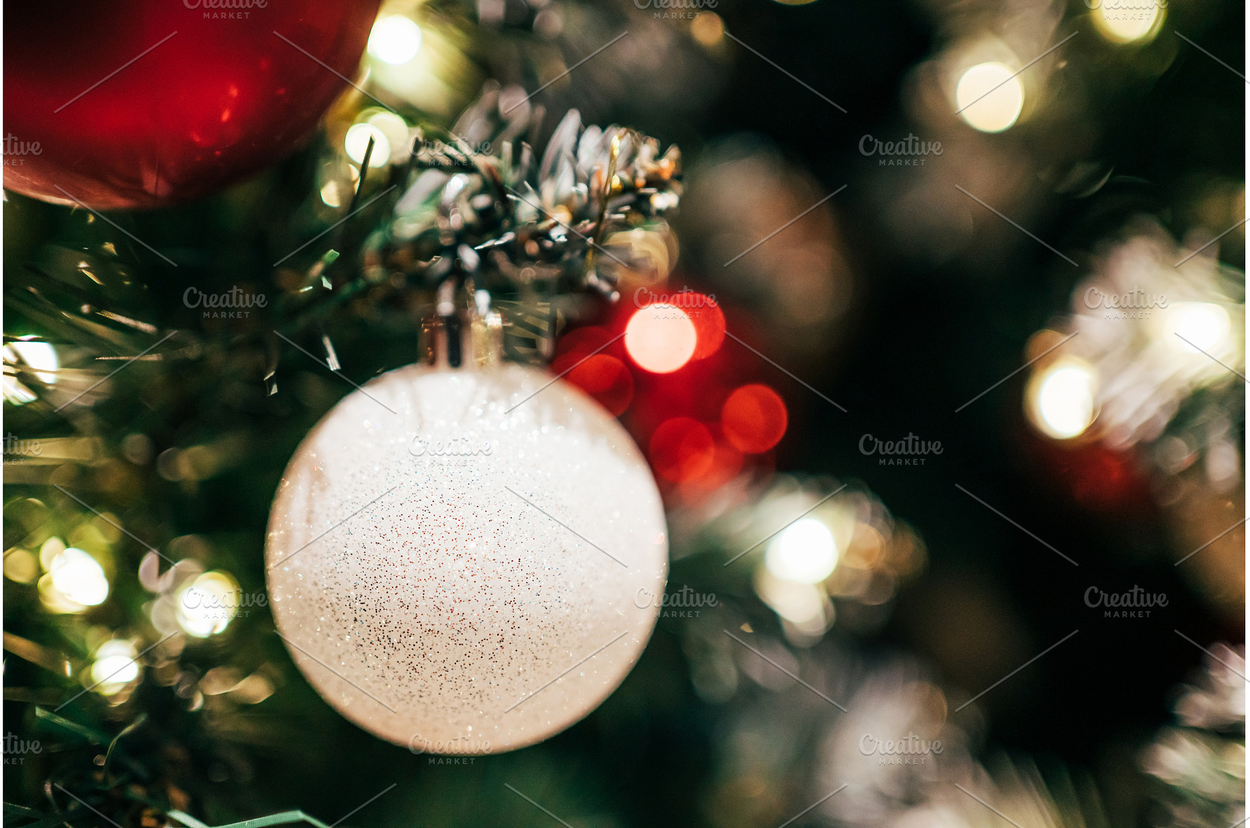 Glittering white ornament hanging on, a Holiday Photo by Anna Efetova