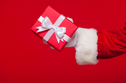 Christmas photo of santa claus gloved hand with red giftbox stock photo, a Holiday Photo by mif