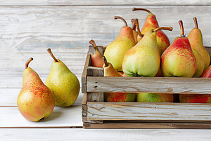 Ripe pears in crate on white wooden table, a Food & Drink Photo by AlyaAnd