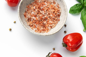 Pink himalayan salt in bowl with fresh tomatoes and basil, a Food & Drink Photo by Olena Rudo