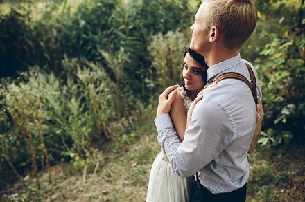Groom gently embracing his bride stock photo containing couple and wedding, a Person Photo by Tekso