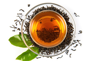 Top view of cup of aromatic tea and green mint leafs on white background, a Food & Drink Photo by AlyaAnd