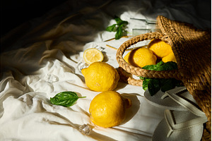 Bright summer lemons in a woven bag, a Food & Drink Photo by IlliaBondarPhotography