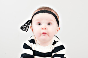 Cheeky baby girl stock picture