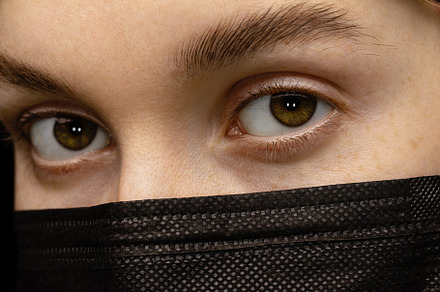 Woman in a black medical mask.