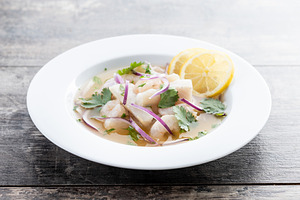 Traditional Peruvian ceviche sea bass fillet on wooden table, a Food & Drink Photo by etorres69