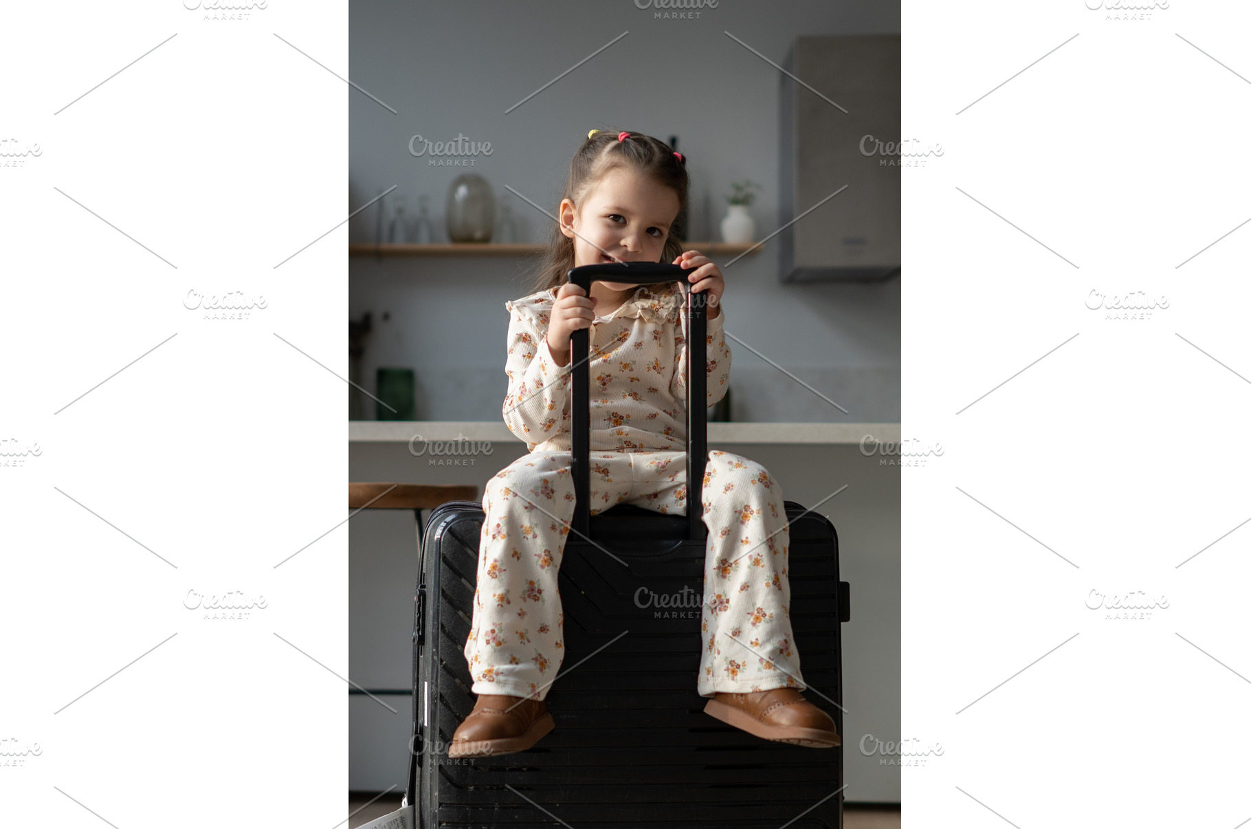 Little girl sitting on a suitcase in, a Holiday Photo by undrey