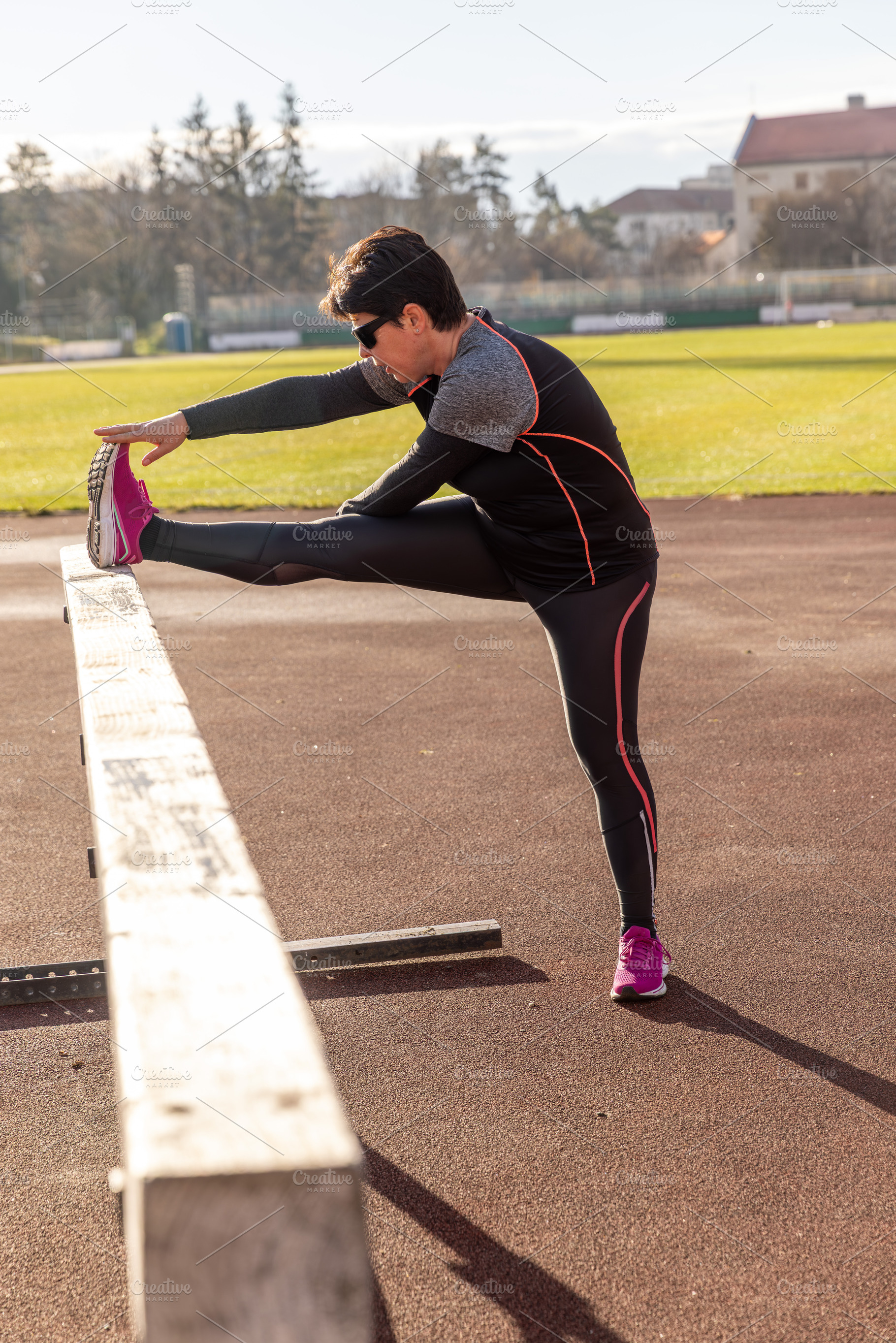 Athlete woman stretching leg, a Photo by Grafvision photography