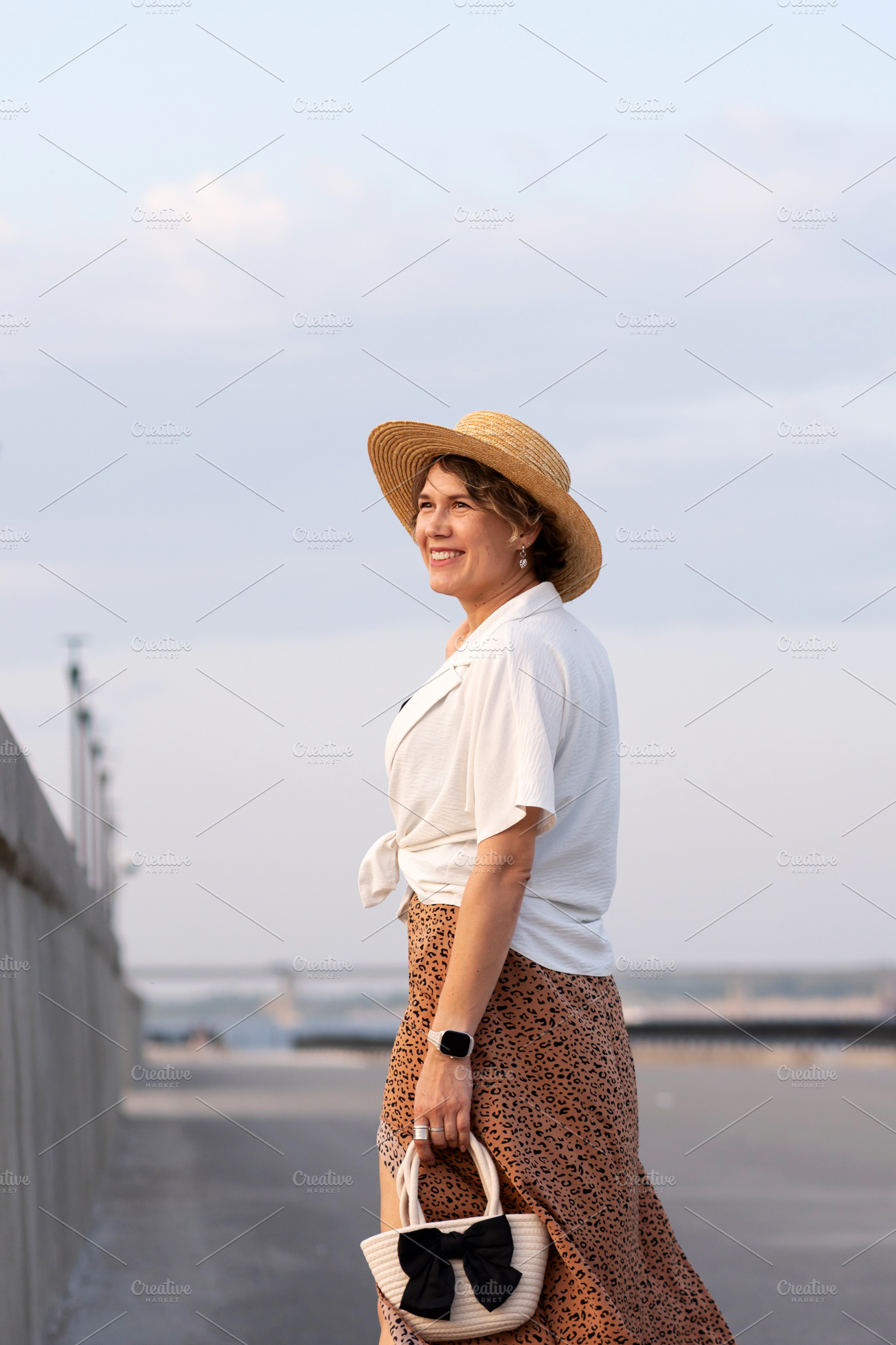Smiling woman wearing straw hat walk, a Person Photo by Elena Vagengeim