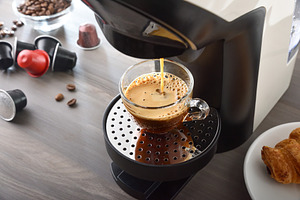 Capsule coffee maker preparing espresso on wooden bench elevated, a Food & Drink Photo by Davizro's Market