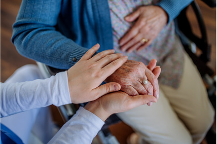 Top view of nurse stroking hands of, a Person Photo by HalfPoint