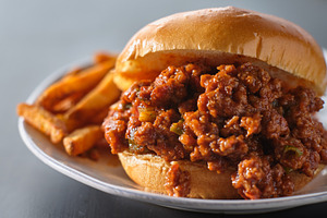 sloppy joe on plate with fries