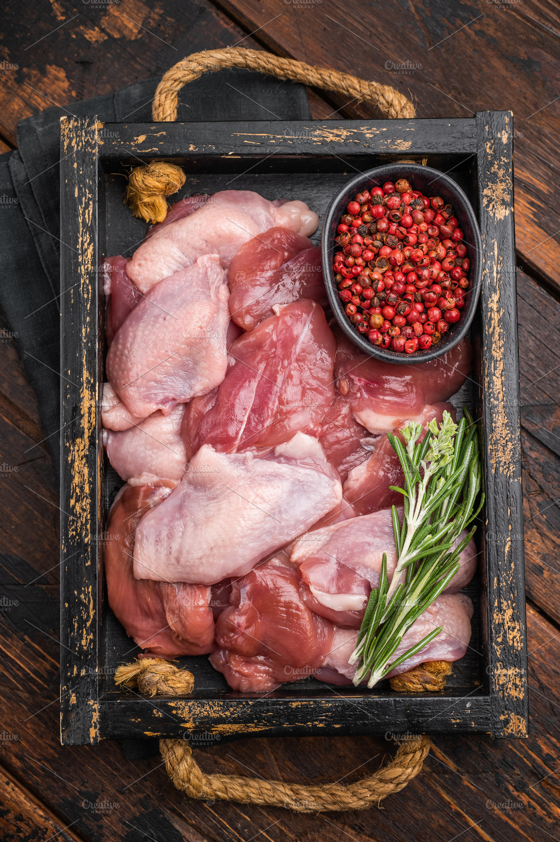 Uncooked, skin-on quail fillets with fresh spices in a rustic bo, a Food & Drink Photo by composter-box@mail.ru