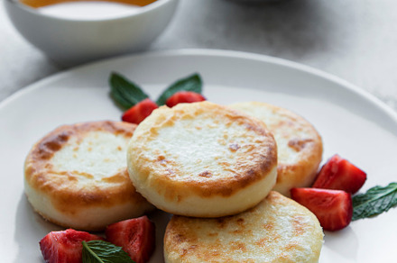 Cottage cheese pancakes, ricotta fritters on ceramic plate with, a Food & Drink Photo by Olena Rudo