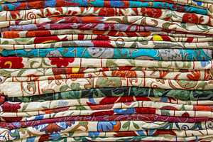 Colorful stacked woven fabric, a Background Photo by BOOCYS