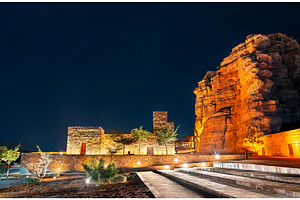 Illuminated traditional stone buildings in AlUla Old Town