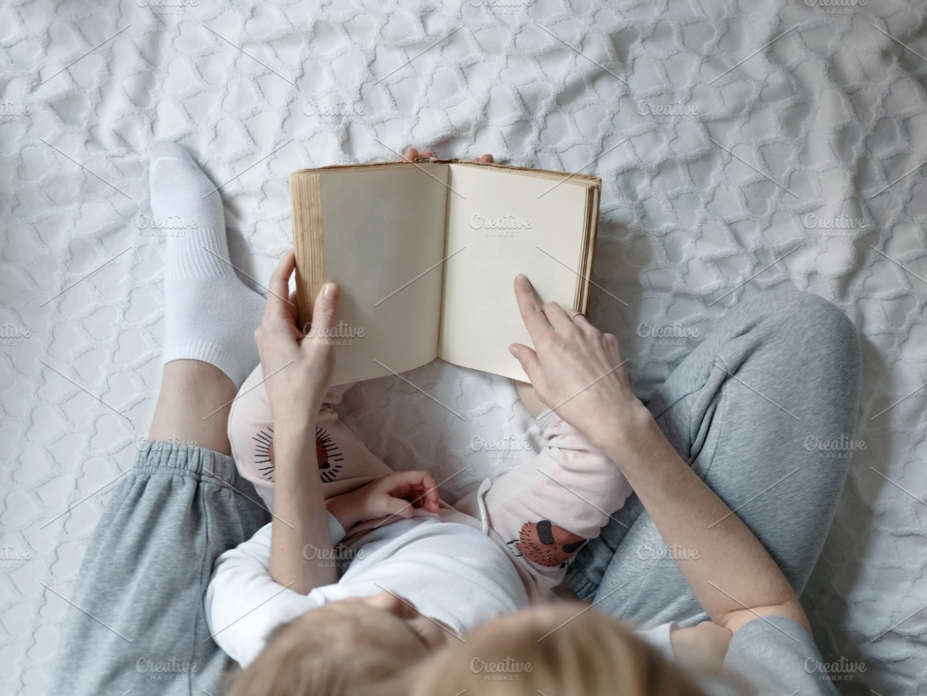 Mother reading book to her daughter stock photo containing love and lifestyle, a Person Photo by Tinyakov Story