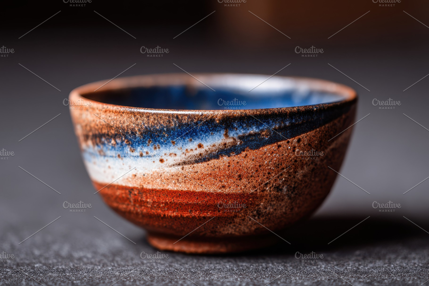 Rustic handmade ceramic bowl with blue and white glaze, an Abstract Photo by AlyaAnd