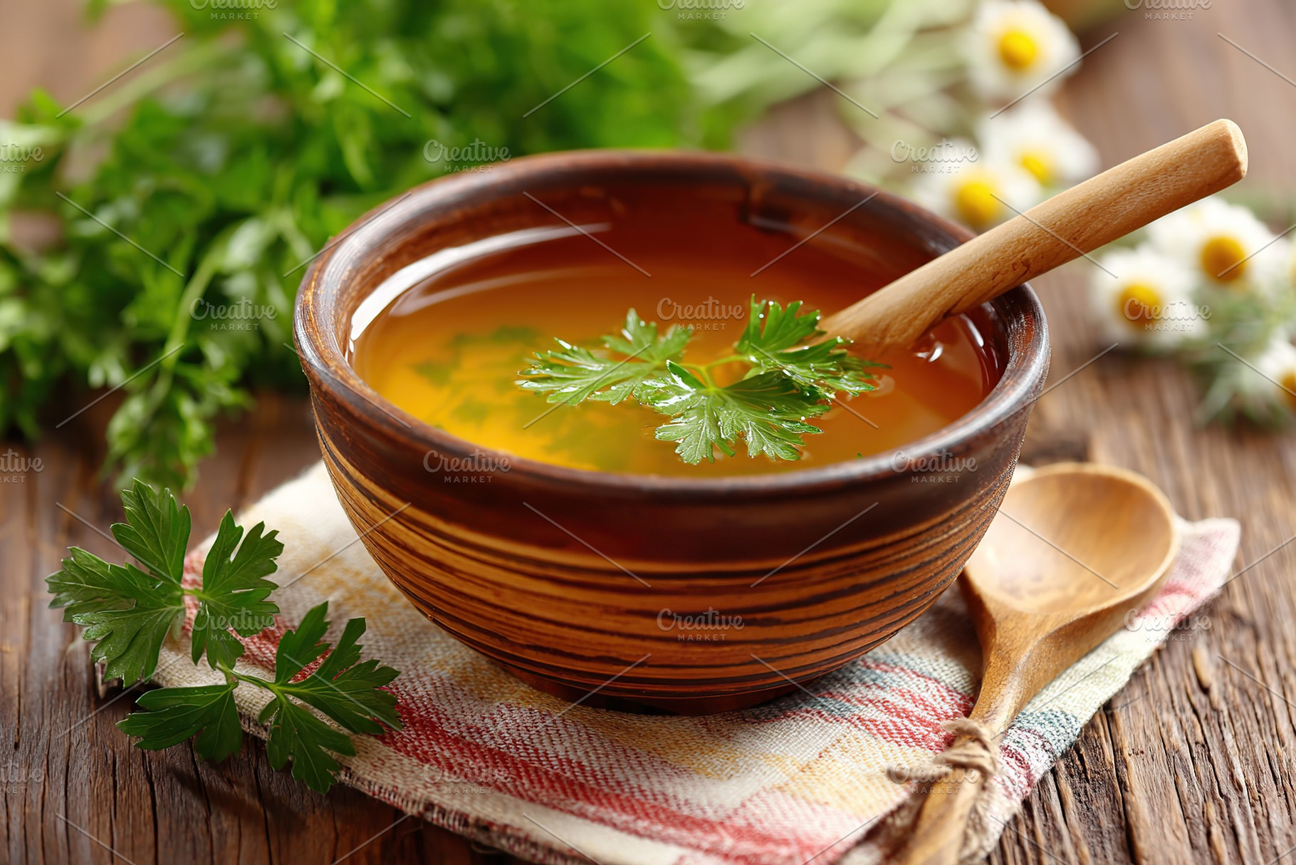 Warm soup in a handmade ceramic bowl with fresh herbs on a rustic wooden table, a Food & Drink Photo by AlyaAnd