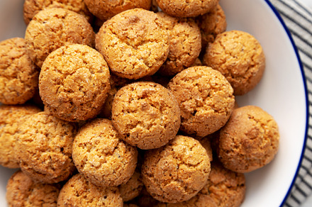 Homemade Sweet and Crunchy Amaretti on a Plate, top view. Flat l, a Food & Drink Photo by LiudmylaChuhunova