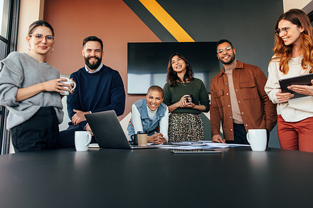 Young businesspeople smiling happily in a boardroom, a Person Photo by Jacob Lund