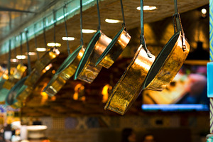 Shiny red copper pans in restaurant