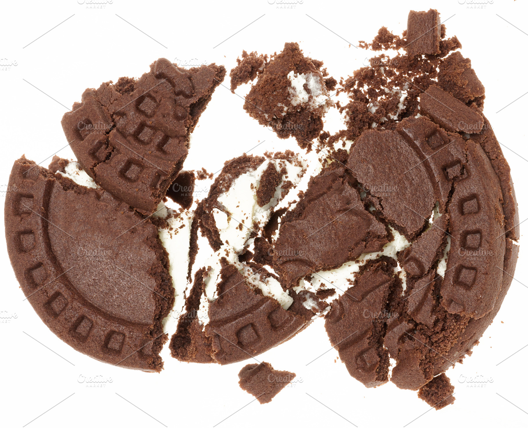 Broken chocolate chip cookies with white cream filling on white, a Food & Drink Photo by ndanko