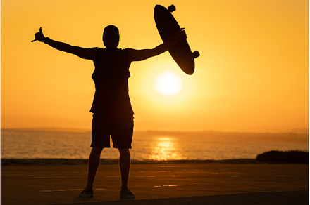 Silhouette of a man showing a shaka, a Person Photo by Barcelona_dreams