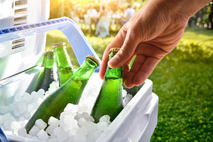 Hand Taking Cold Bottles From Cooler, a Food & Drink Photo by Davizro's Market
