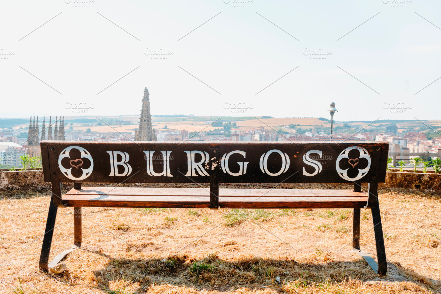 bench on Castle Hill facing Burgos Cathedral tower view, a Photo by Nito