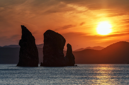 Scenery sunset over rocks in ocean, a Nature Photo by Alexander-Piragis