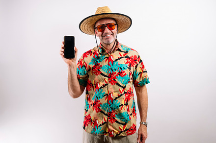 Mature tourist holding phone with blank screen