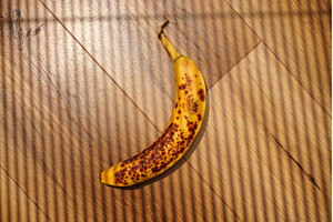 Brown-spotted banana resting on, a Background Photo by darksoul72