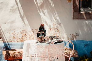 Cat napping on lace patio table, a Wallpaper Photo by SkyNext