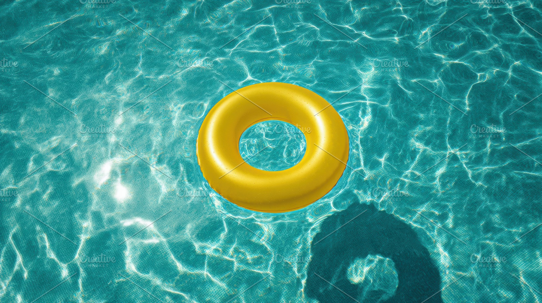 Yellow inflatable ring in pool water, a Photo by Virgo Studio