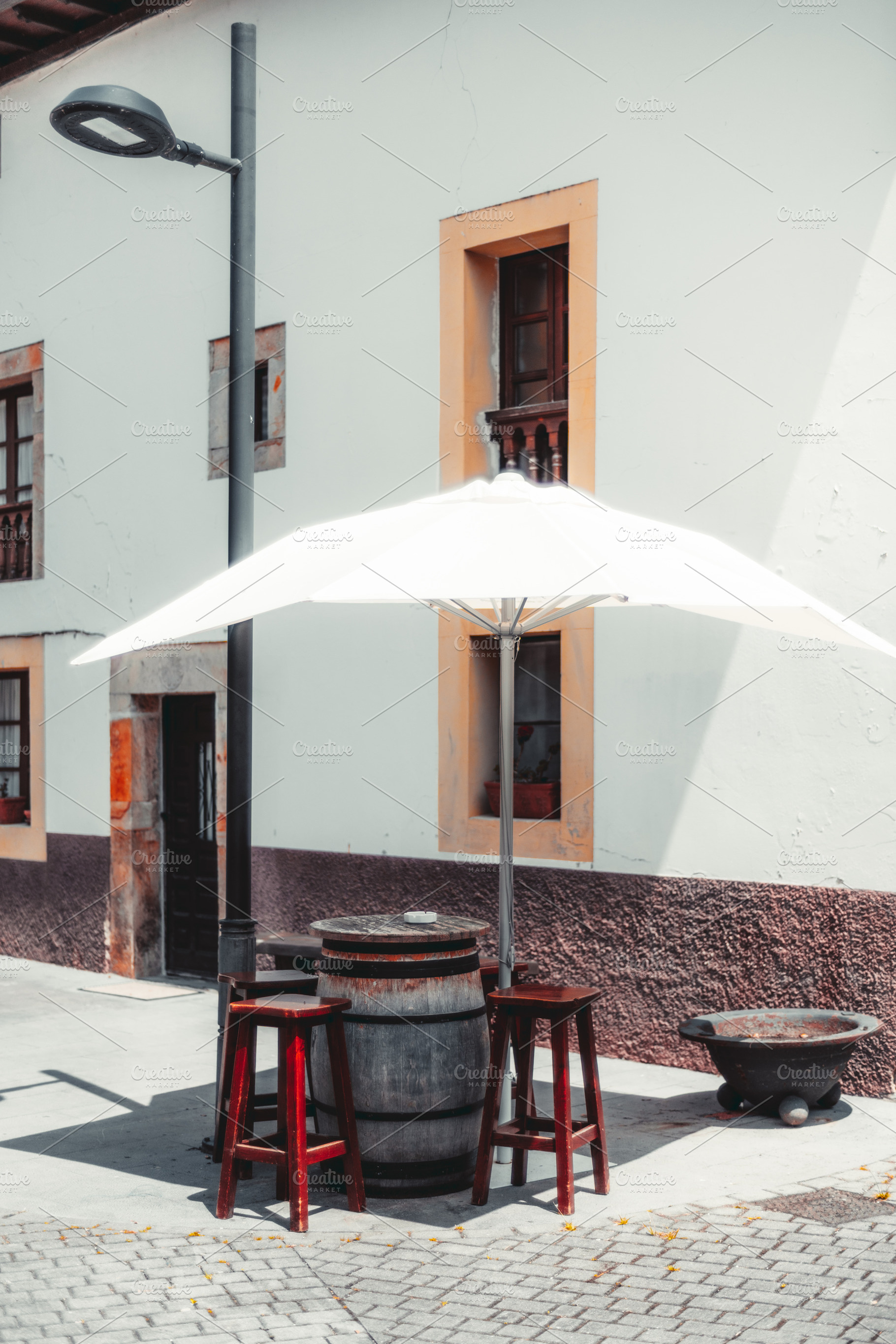 Barrel table with stools, umbrella, an Industrial Photo by SkyNext