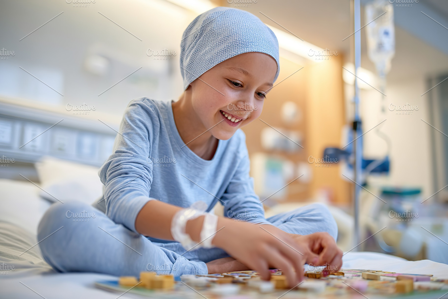 Child engaged in playful activity while recovering in a hospital room during da, a Photo by AlyaAnd
