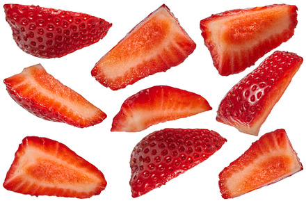 Set of sliced red fresh strawberry wedges arranged in diff