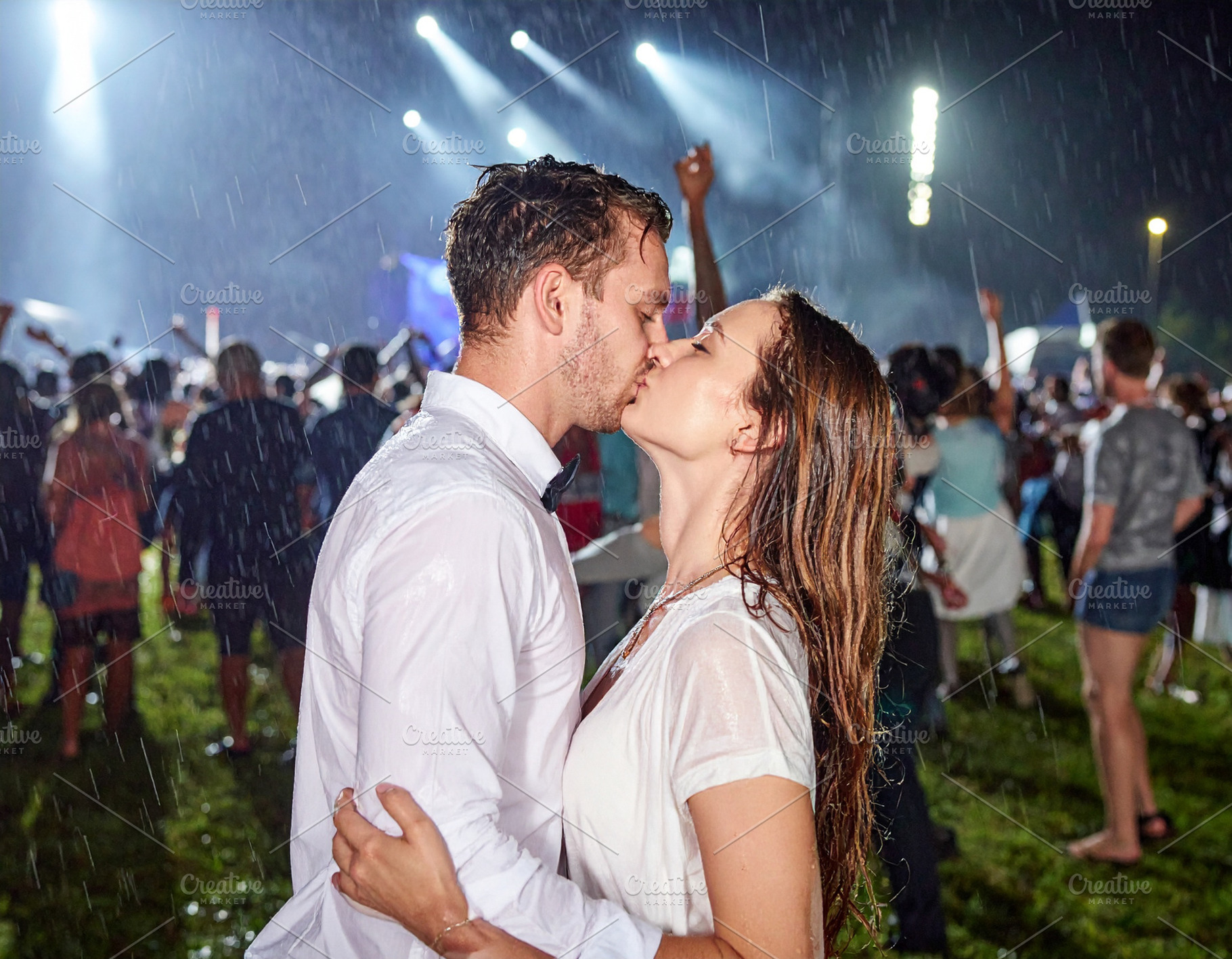 Young couple kisses passionately under torrential rain at an out, a Person Photo by DanFLCreativo
