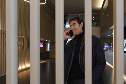 Mature businessman with smartphone by ear while entering hall of contemporary h, a Person Photo by 2Design