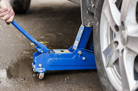 Changing car wheel with hand jack, a Transportation Photo by AlexBush