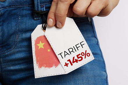 Hand Holding Jeans Price Tag with Tariff Marking, a Business Photo by Alliance Images