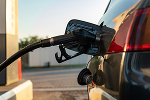 Close-up of a black car being refueled at a gas station during daylight, highli, a Transportation Photo by Ales Munt