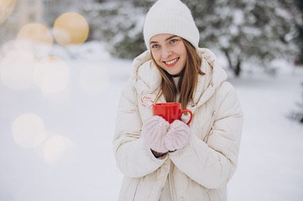 Cute happy woman holding hot coffee, a Holiday Photo by Cherkas Photography