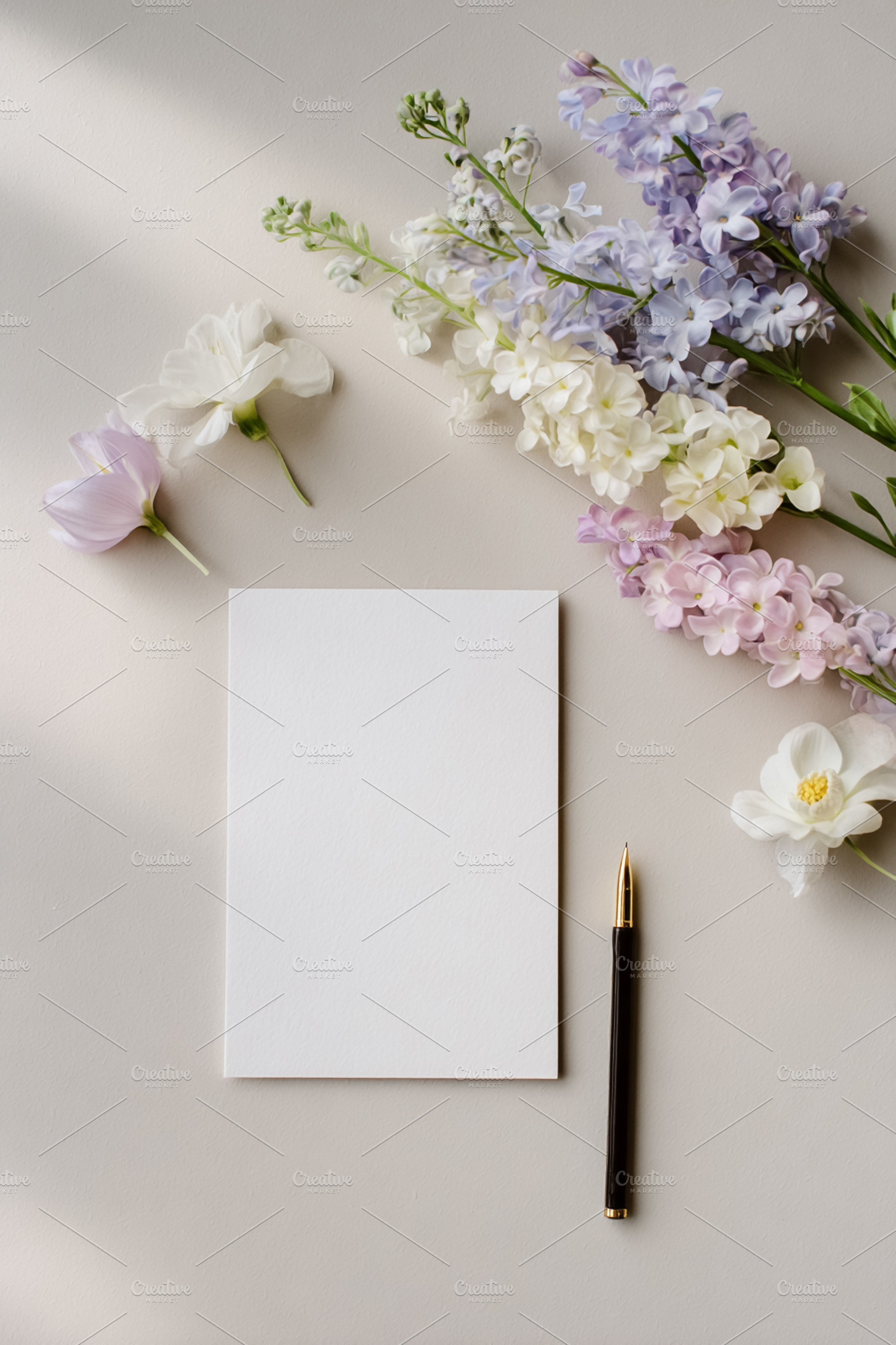Blank vertical card with pen and fresh stock flowers creating a, a Photo by Studio ANNA