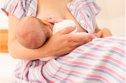 The mom is breastfeeding her newborn, a Health & Medical Photo by oksix