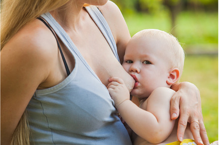 Mother breastfeeding her toddler, a Person Photo by oksix