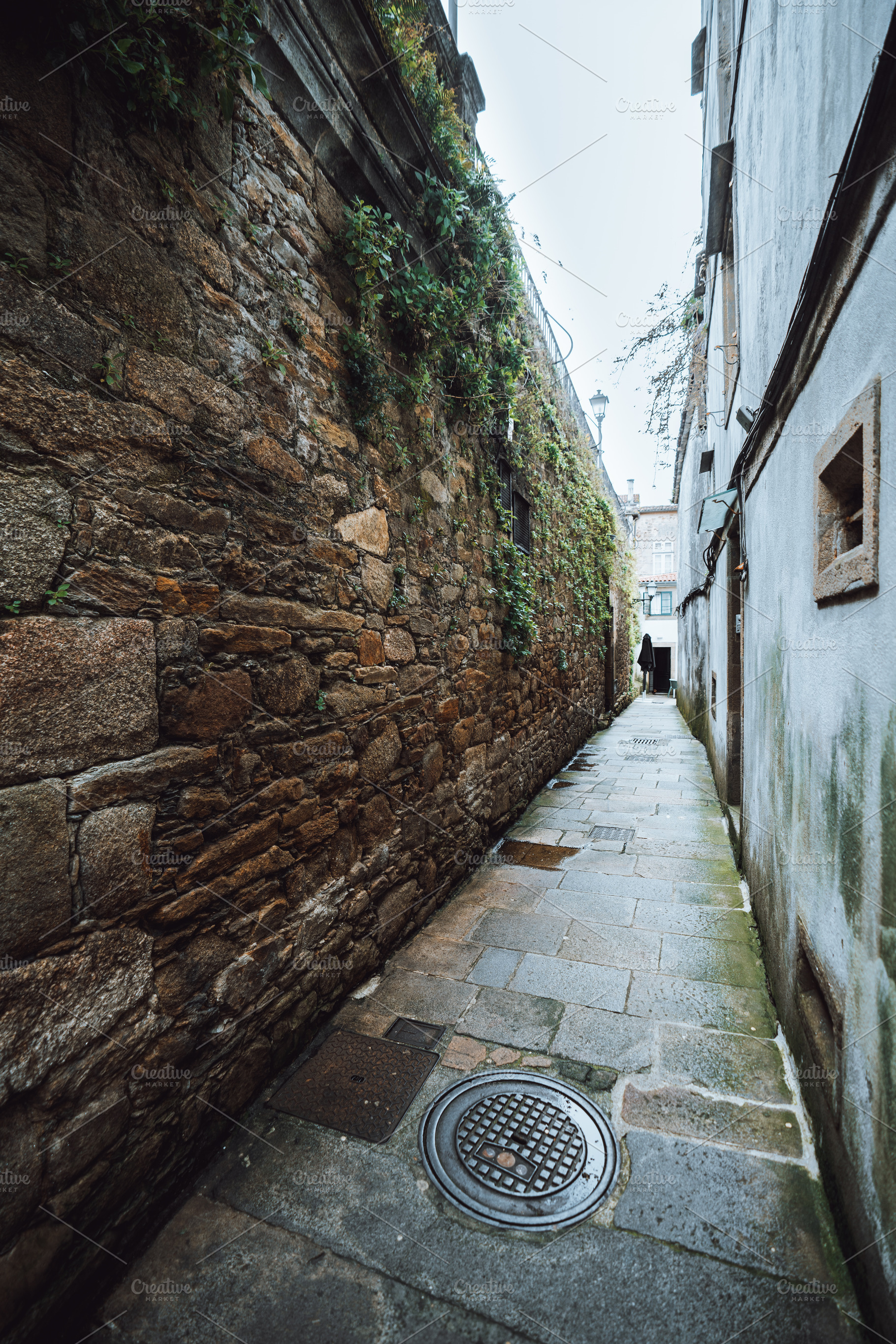 Narrow stone alley in old town rain, an Architecture Photo by SkyNext