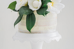 Naked wedding cake with camellias stock photo containing wedding cake and