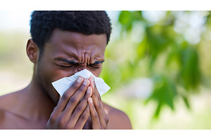 Black man blowing nose with tissue, a Person Photo by Lermont51